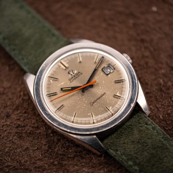 Omega Seamaster 166.028 automatic dial photographed at an angle with forest green Italian suede strap