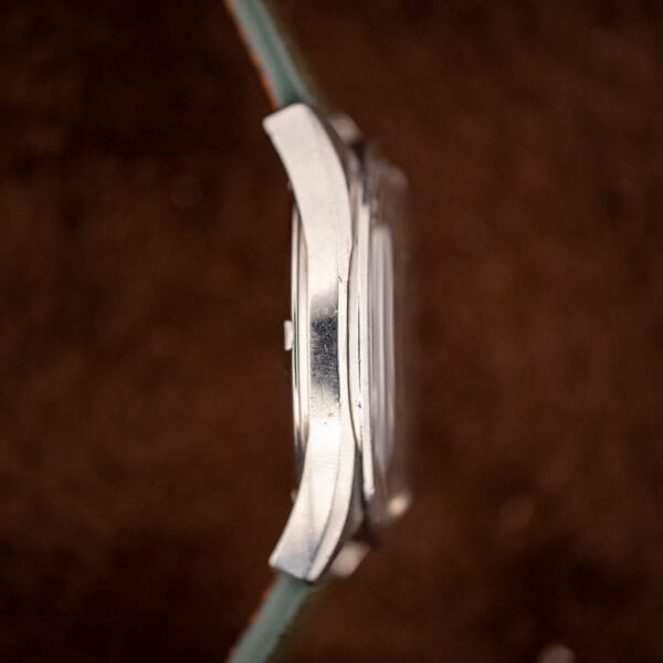 Omega Seamaster 166.028 case flank and twisted lugs showing honest hairline wear