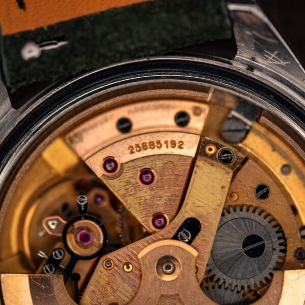 Omega automatic movement bridge close-up showing serial number 25685192 and gilt finish
