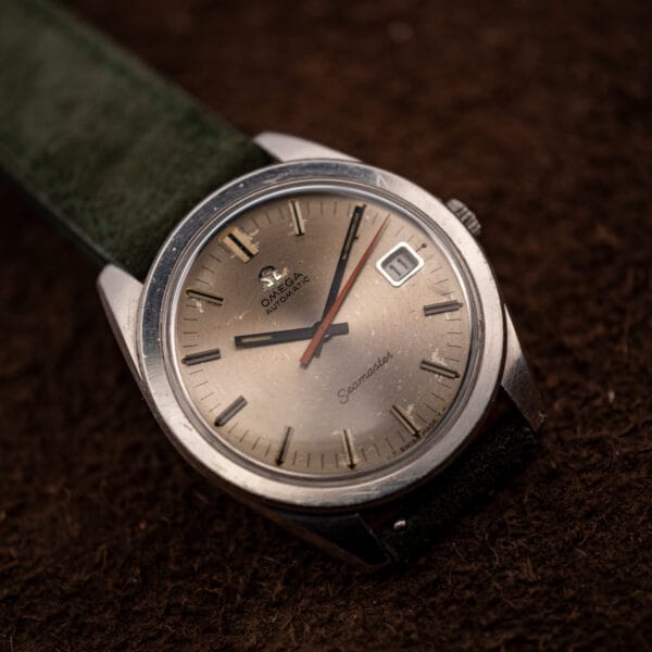 Omega Seamaster 166.028 automatic on a forest green suede strap, angled dial and case view