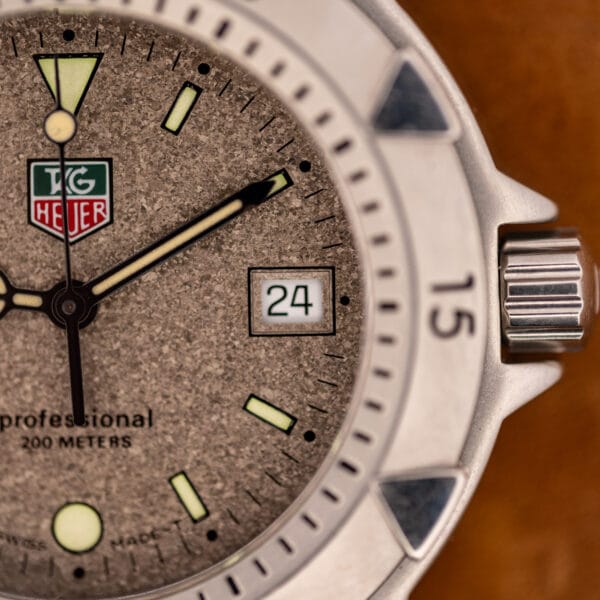 TAG Heuer 1500 Series granite dial detail showing framed date window at three and signed crown
