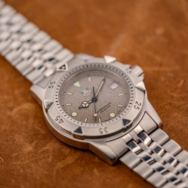 Vintage TAG Heuer 1500 Series professional 200 meters diver with stone dial, three-quarter profile on leather
