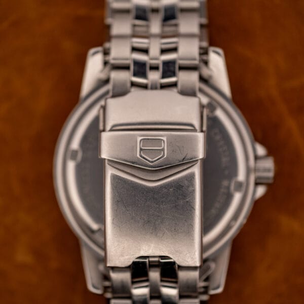 TAG Heuer 1500 Series deployant clasp with shield logo pressed into the cover, bracelet reverse