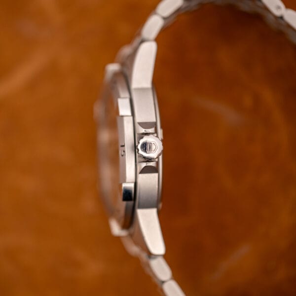 TAG Heuer 1500 Series case side profile showing signed crown with shield logo and bezel edge