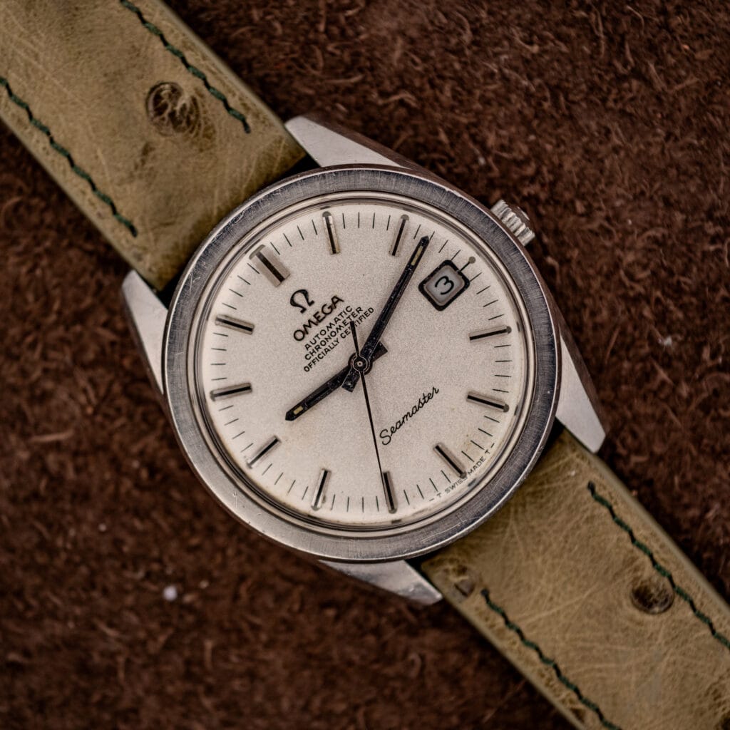 Omega Seamaster Chronometer 168.022 top-down on olive Ostrich strap with sandblasted silver-white dial and date at three