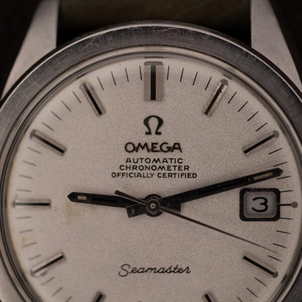 Omega Seamaster 168.022 sandblasted dial close-up showing Seamaster script and framed date window at three