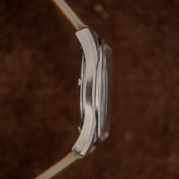 Omega Seamaster slim stainless steel case band shown in side profile with brushed finish