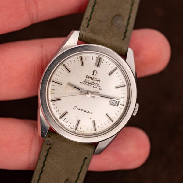 Omega Seamaster 168.022 held in hand, full dial with T SWISS MADE T tritium signature at six