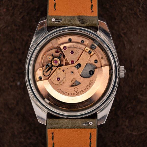Omega caliber 564 automatic movement under open caseback, copper bridges and rotor signed OMEGA WATCH Co SWISS