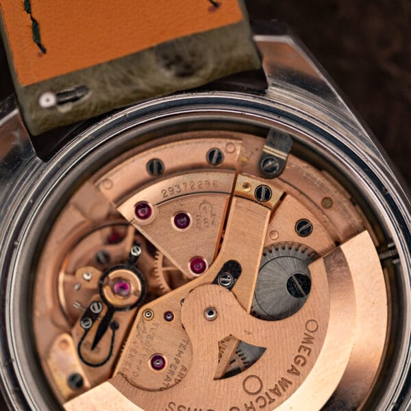 Omega caliber 564 movement macro showing the Omega-stamped bridge, serial number and jewel count