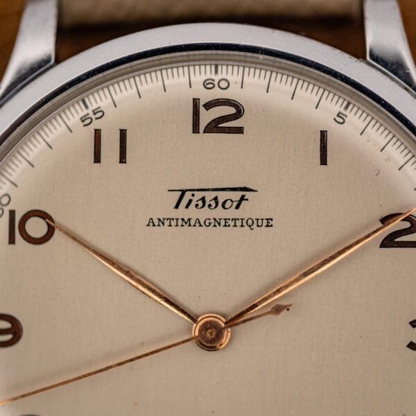 Tissot Antimagnetique 66718 dial close-up showing Tissot script over ANTIMAGNETIQUE and rose-gilt center seconds hand