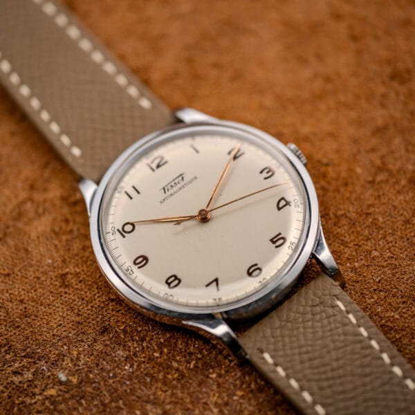 Tissot Antimagnetique Jumbo 66718 stainless steel case flat-lay on tan suede, cream dial and gilt numerals