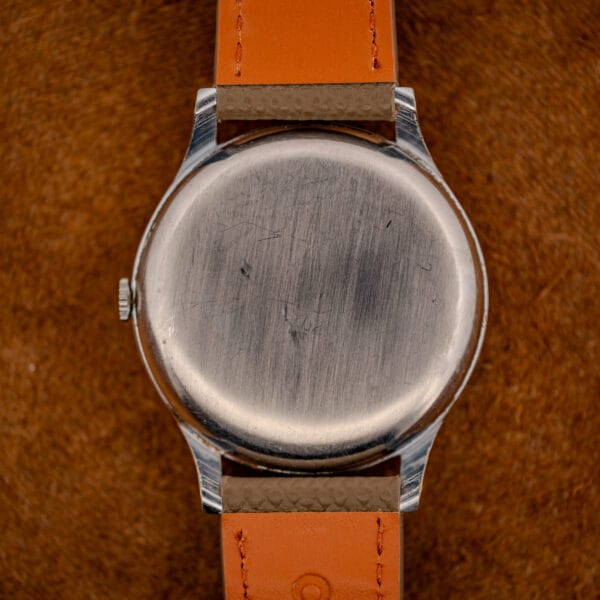 Tissot 66718 polished stainless steel snap caseback showing honest scratches from wrist time