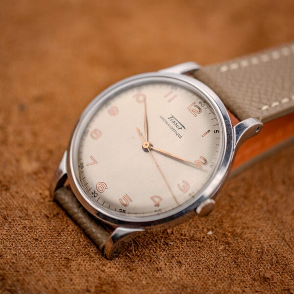 Tissot Antimagnetique Jumbo 66718 dynamic angle showing gilt Arabic numerals and grey-taupe leather strap