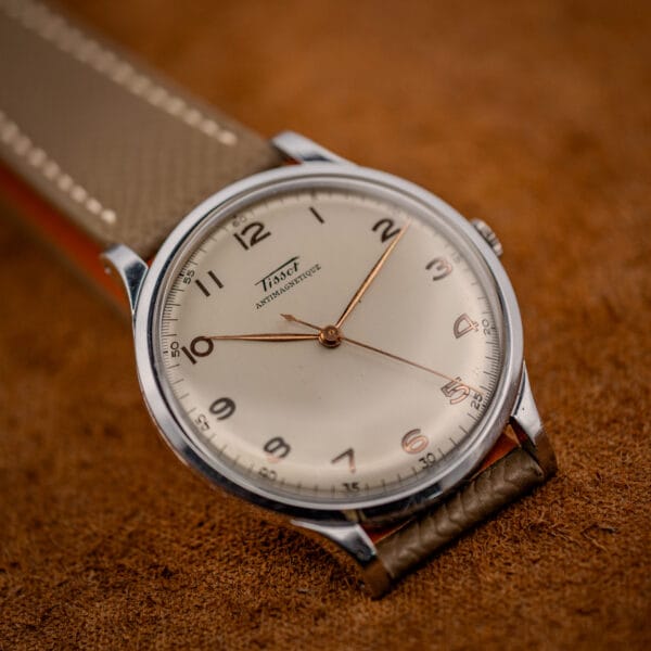 Tissot Antimagnetique 66718 angled on grey-taupe leather, rose-gilt leaf hands over warm eggshell dial