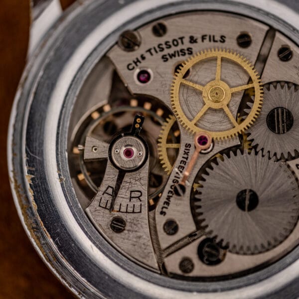 Tissot 27.2 movement close-up, CHs TISSOT & FILS SWISS bridge with SIXTEEN JEWELS and A/R regulator index
