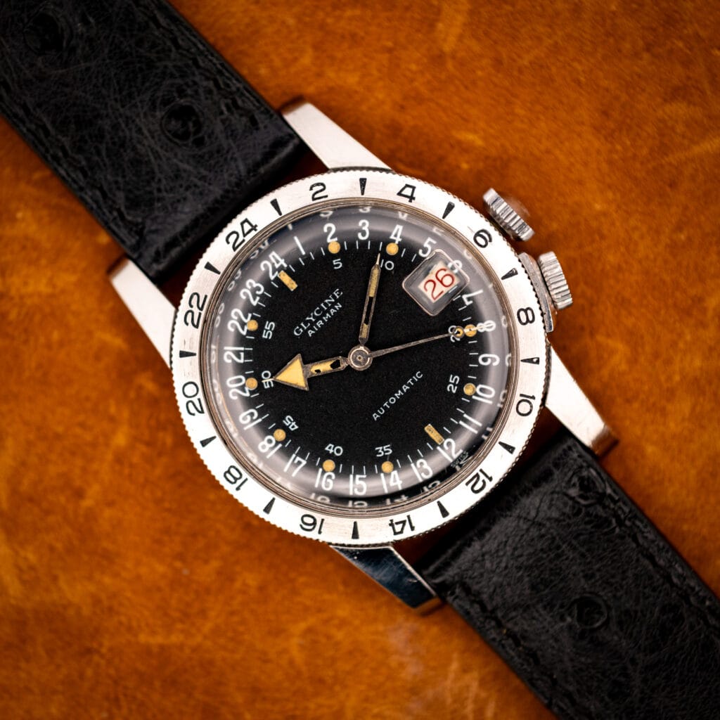 Glycine Airman GMT automatic black 24-hour dial on black ostrich strap, top-down view