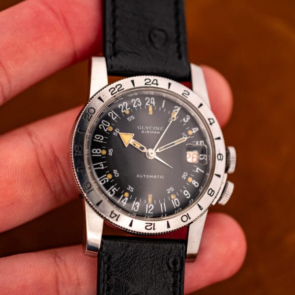Glycine Airman held in hand showing 24-hour dial, red date and OTTUHR signed ostrich strap