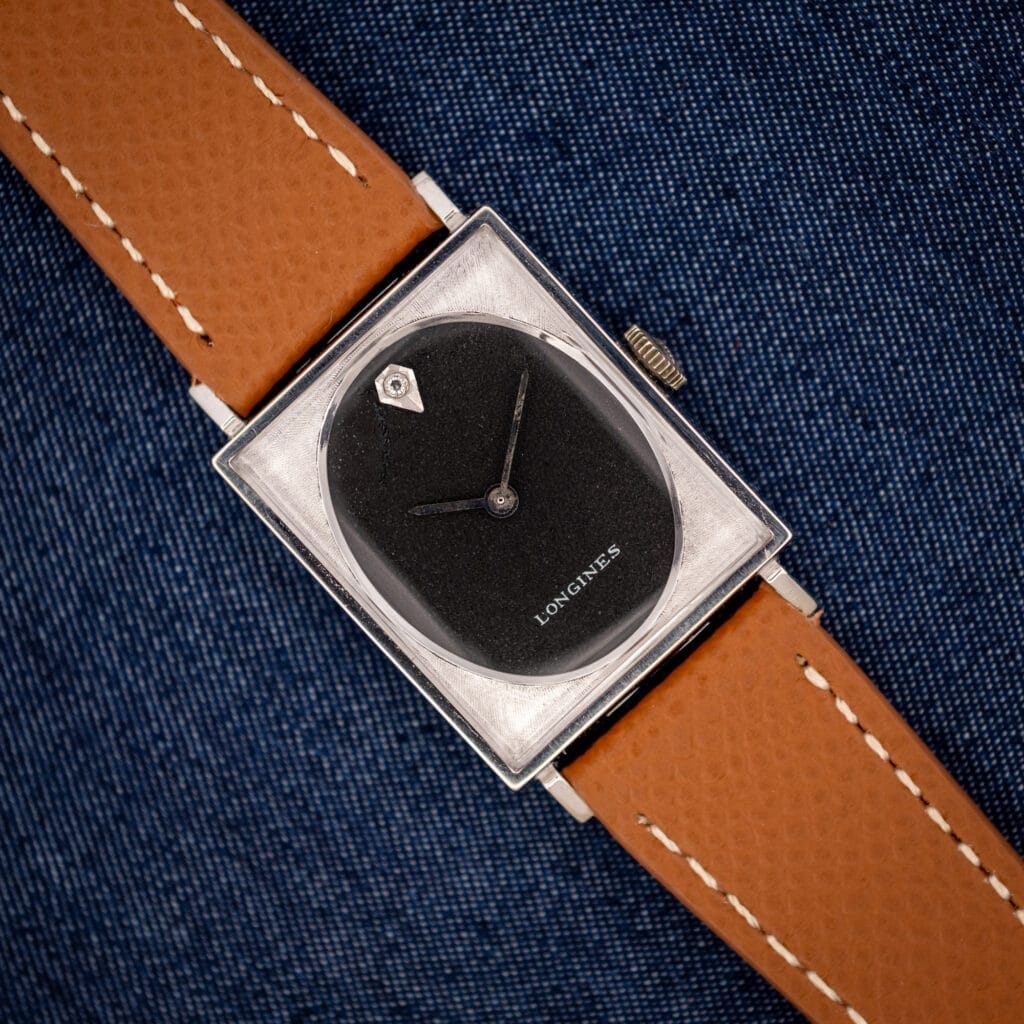 Vintage Longines Tank 3007-528 black oval dial in engine-turned square white gold filled case on honey strap