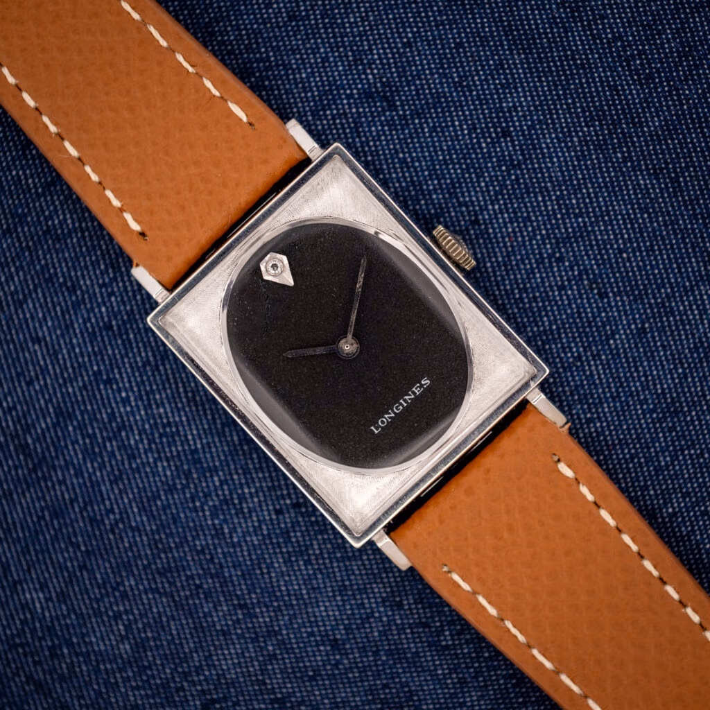 Vintage Longines Tank 3007-528 black oval dial in engine-turned square white gold filled case on honey strap