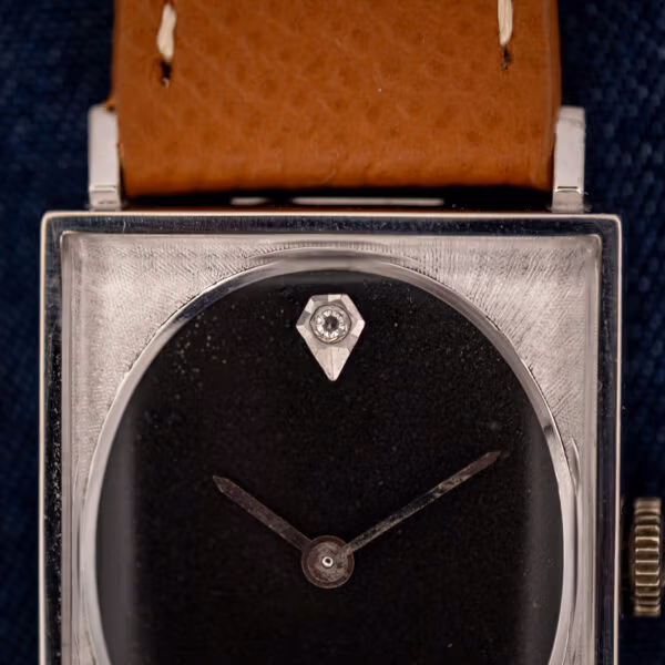 Longines 3007-528 black dial macro with single diamond marker at twelve and slim baton hands