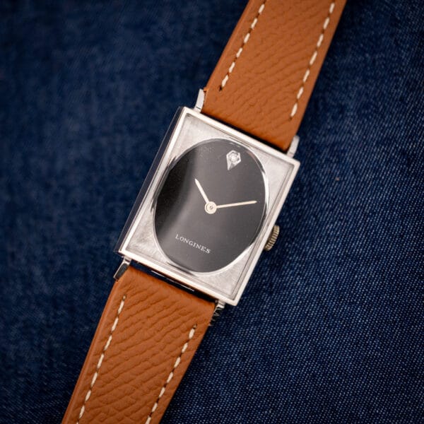 Vintage Longines-Wittnauer tank 3007-528 angled, black oval dial inside textured square frame, honey leather strap