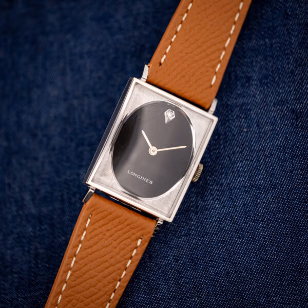 Vintage Longines-Wittnauer tank 3007-528 angled, black oval dial inside textured square frame, honey leather strap
