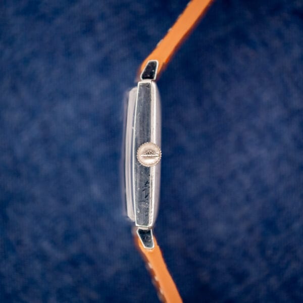 Vintage Longines tank side profile with Longines signed winged-hourglass crown at three