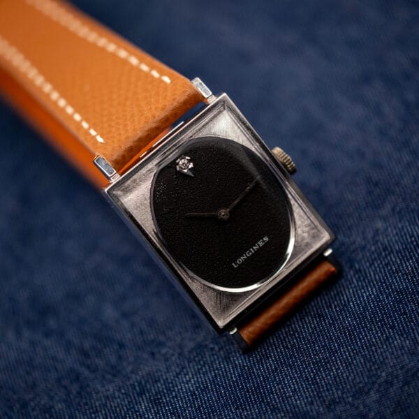 Longines 3007-528 black oval dial close angle, diamond at twelve and engine-turned square bezel
