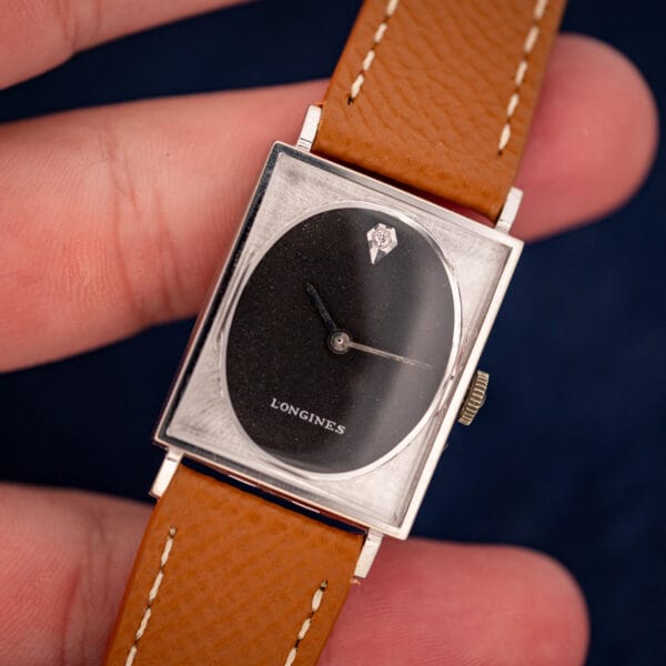 Vintage Longines tank 3007-528 in hand, black dial signed LONGINES with single diamond accent