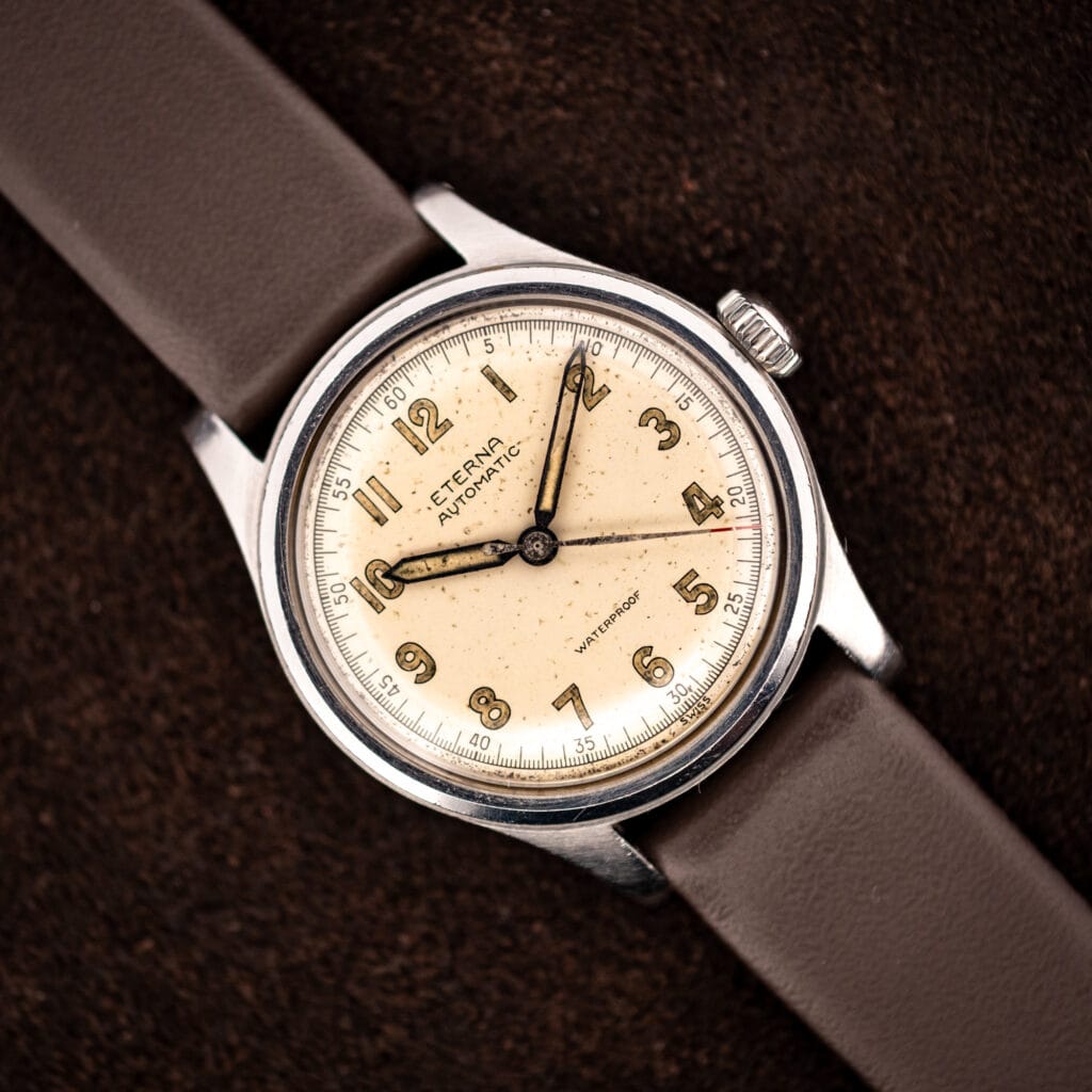 Vintage Eterna automatic bumper Cal. 835 angled on brown leather strap, warm cream military-style dial