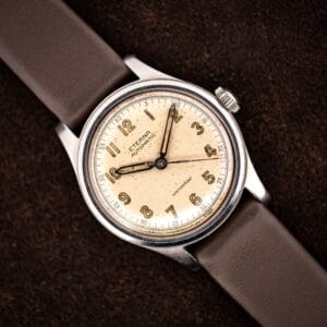Vintage Eterna automatic bumper Cal. 835 angled on brown leather strap, warm cream military-style dial