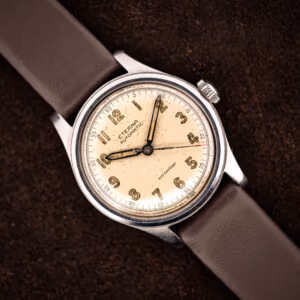 Vintage Eterna automatic bumper Cal. 835 angled on brown leather strap, warm cream military-style dial