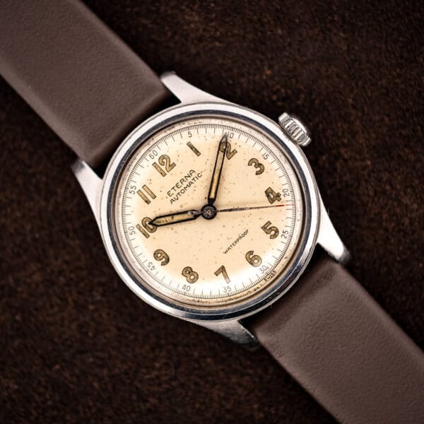 Vintage Eterna automatic bumper Cal. 835 angled on brown leather strap, warm cream military-style dial