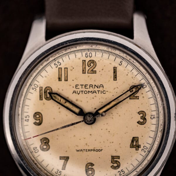Eterna Automatic cream dial macro, signed ETERNA over AUTOMATIC with WATERPROOF and aged luminous syringe hands