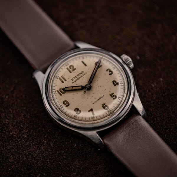 Eterna automatic bumper stainless case angled, brown leather strap, cream dial and crown profile
