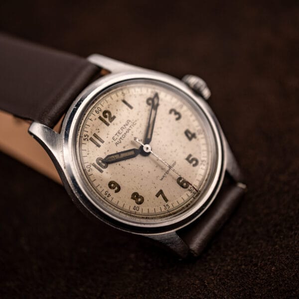 Eterna bumper automatic three-quarter profile, polished stainless case and warm aged cream dial