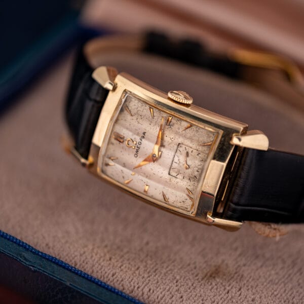 Omega Tank N-6243 propped on the original blue Omega box showing Art Deco case and cream dial