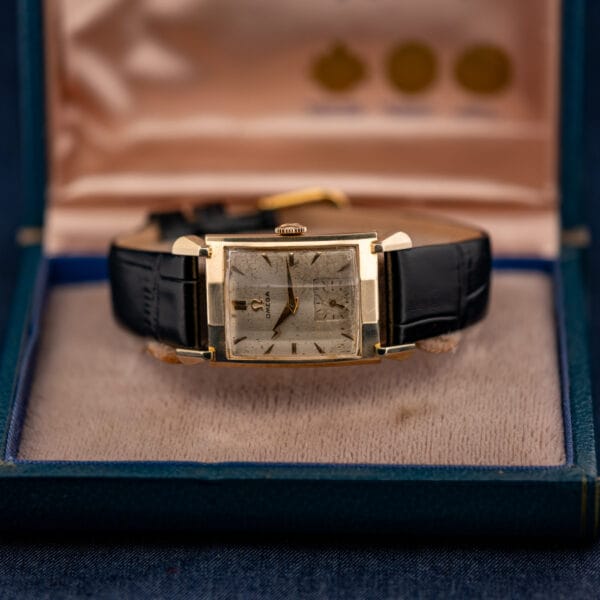 Vintage Omega Tank N-6243 resting in its original Omega box with pink satin interior