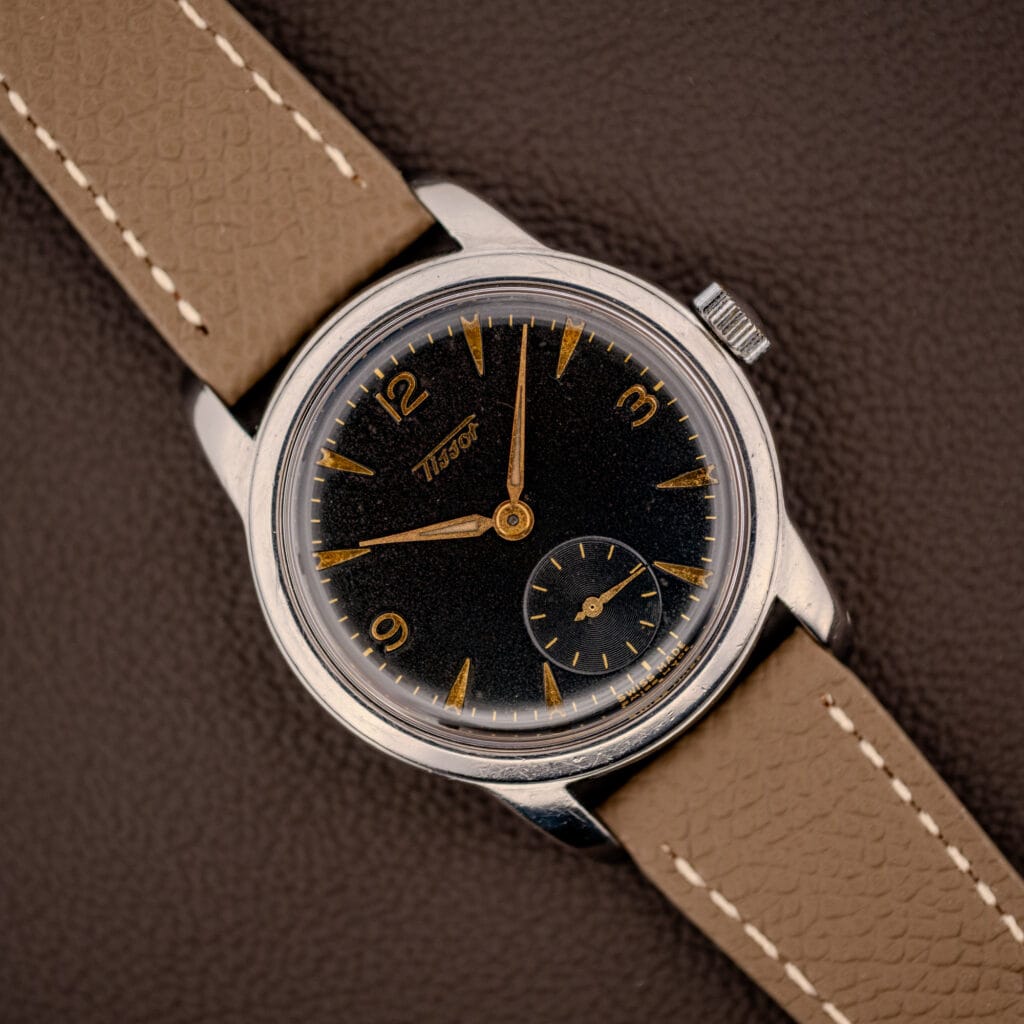 Vintage Tissot ref. 6769 black gilt dial with gold Arabic numerals and dauphine hands on mud grey leather strap