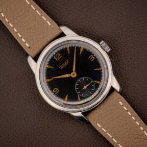 Vintage Tissot ref. 6769 black gilt dial with gold Arabic numerals and dauphine hands on mud grey leather strap