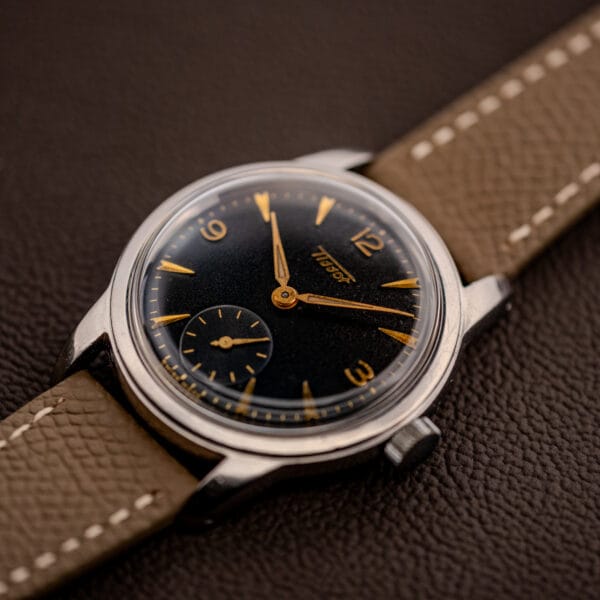 Tissot ref. 6769 black gilt dial three-quarter view with gold numerals and twisted faceted lugs