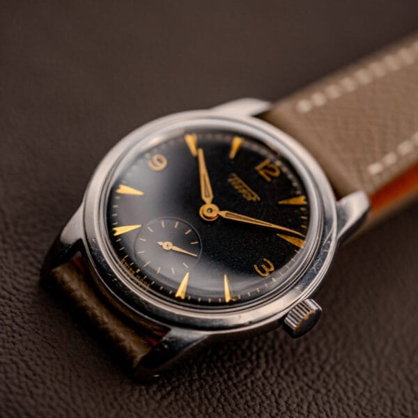 Tissot ref. 6769 low-angle dial shot, gold gilt printing and dauphine hands catching the light