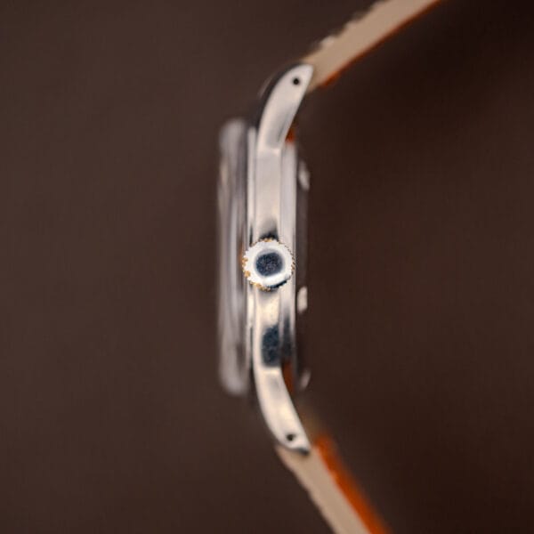 Vintage Tissot 6769 side profile showing the signed crown and polished stainless steel case band