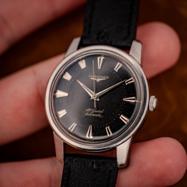 Vintage Longines All Guard 9006-1 stainless automatic held in hand, dial and crown visible