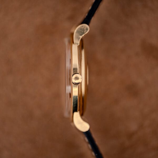 Longines Admiral ref. 69-240 side profile showing the gold filled case band and signed winding crown