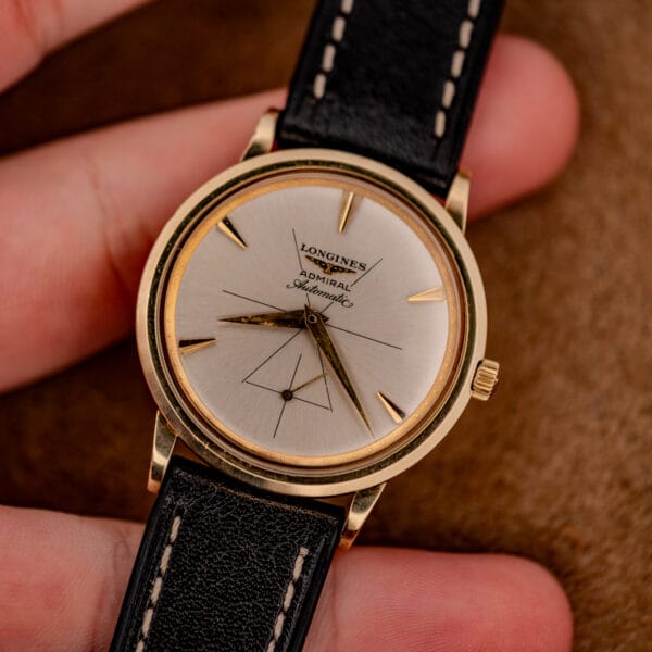 Vintage Longines Admiral gold filled dress watch held in hand showing the triangle small seconds layout at six