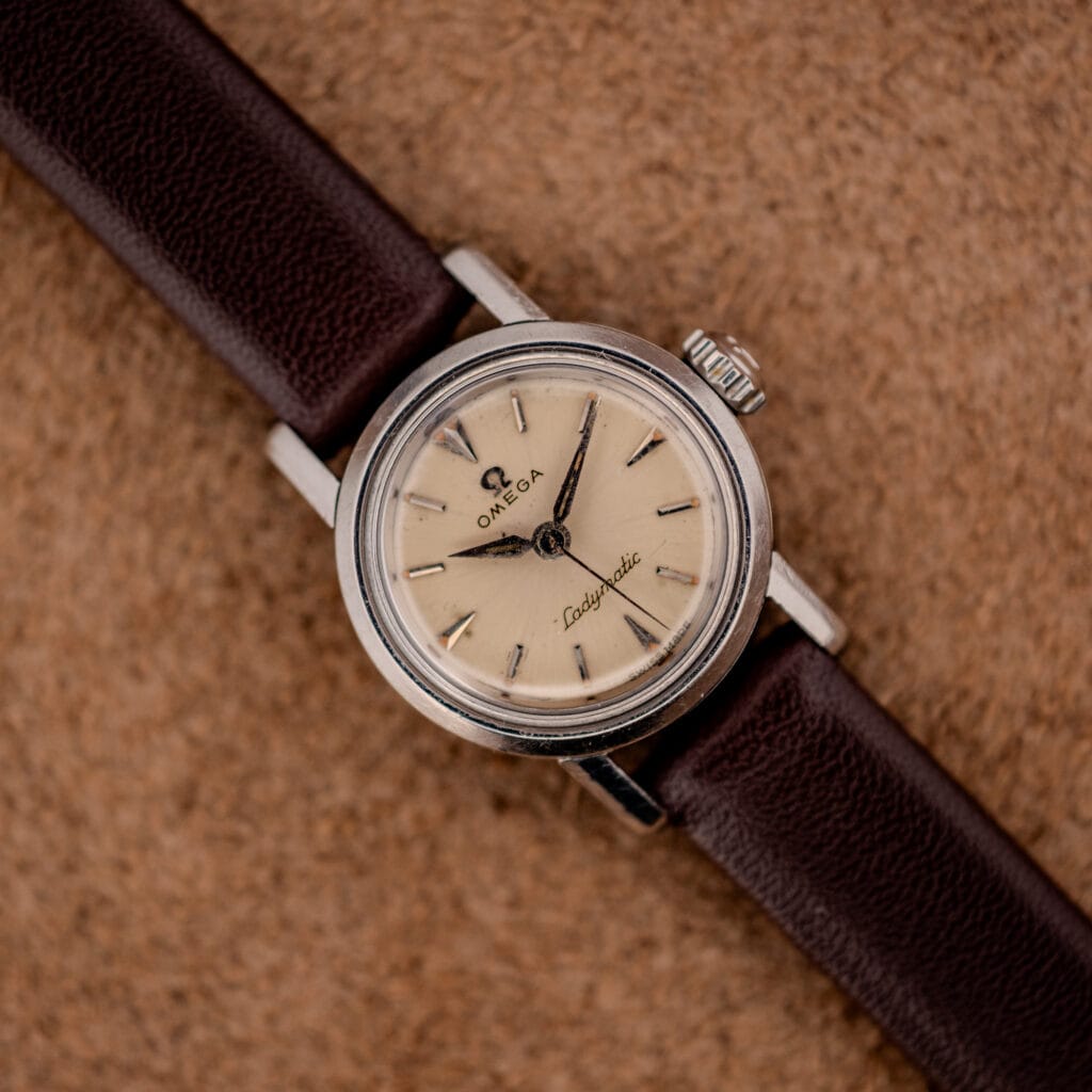 Omega Ladymatic ref. 11000-7 silver dial and stainless case on brown leather strap, top-down view