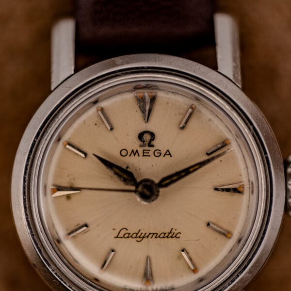 Omega Ladymatic ref. 11000-7 dial at an angle showing the stepped steel bezel and faceted hour markers