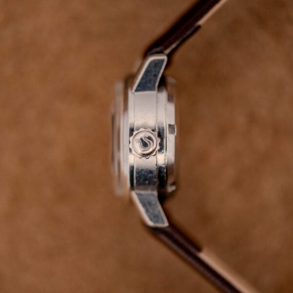 Omega Ladymatic ref. 11000-7 macro side profile with the signed Omega winding crown